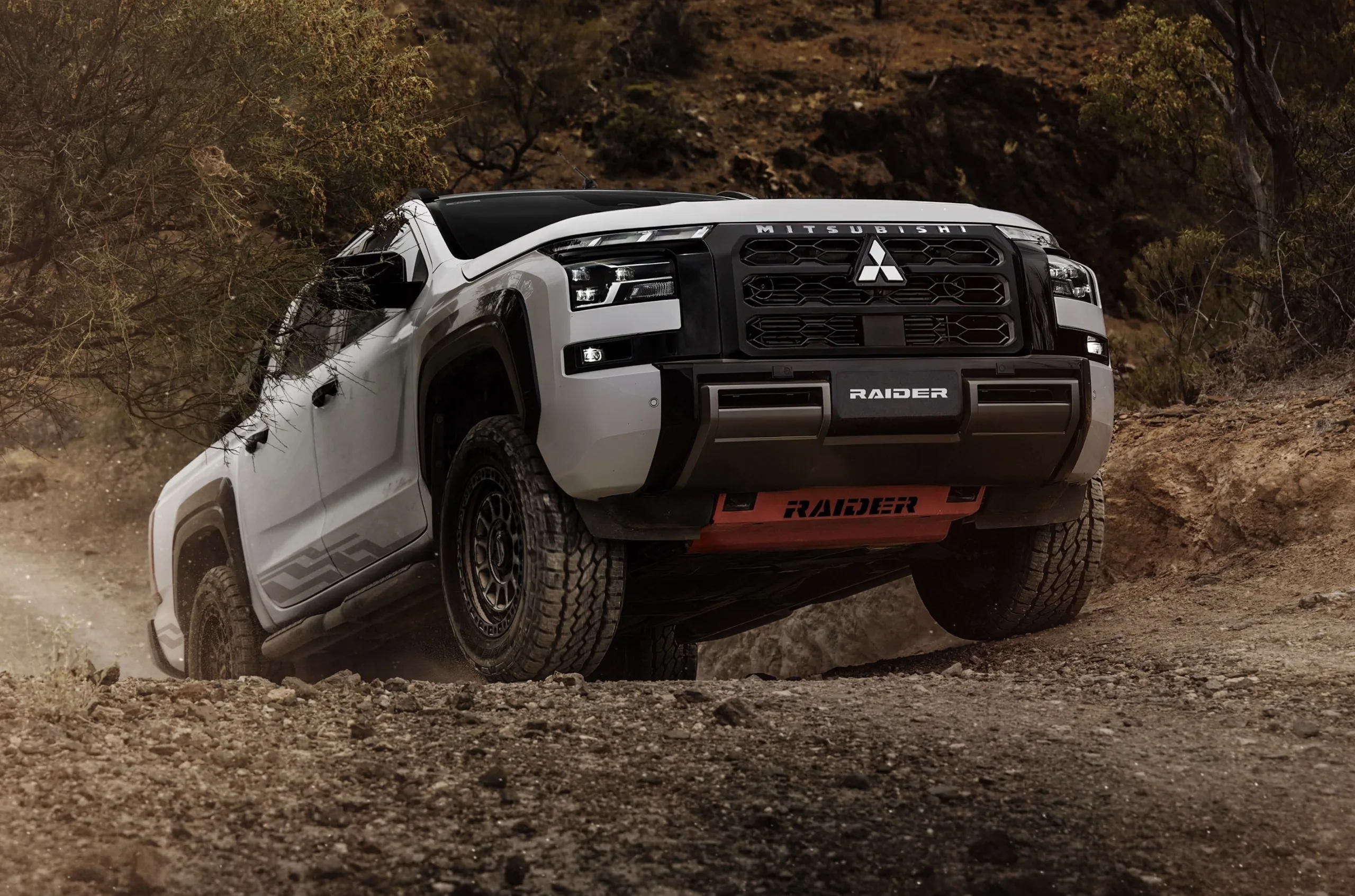 Visual muda bastante com rodas bronze, skid plate vermelha e adesivos Sandstorm que deixam a picape mais chamativa fora do asfalto